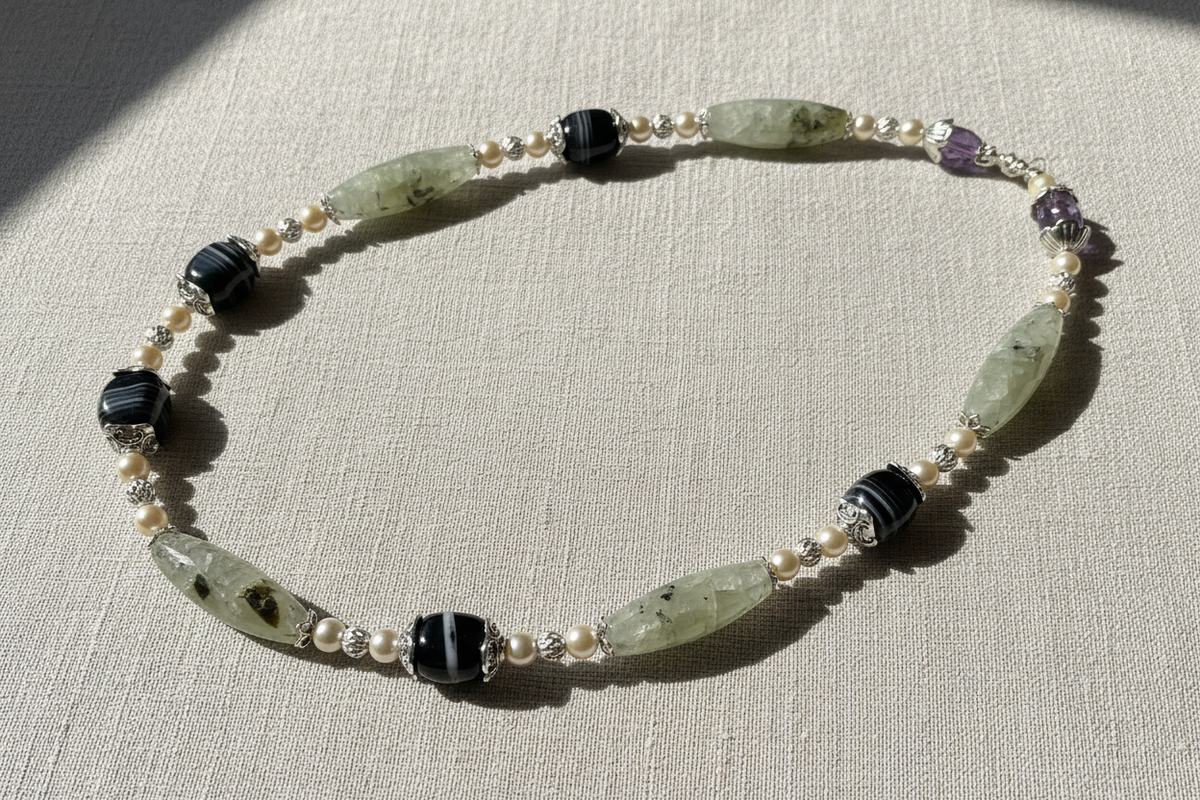 Prehnite necklace flat lay on linen